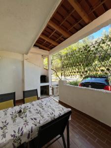 a patio with a table and a car in a yard at Apartmani "Nikola" Seaview - Ivan Dolac, Hvar in Ivan Dolac