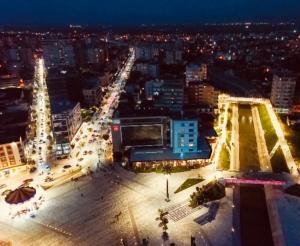 an aerial view of a city at night at Hotel Fieri in Fier