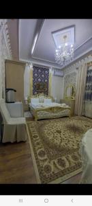 a large bedroom with two beds and a chandelier at UYUT INN Hotel in Samarkand