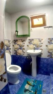 a bathroom with a toilet and a sink at Aspet B&B in Tatʼev