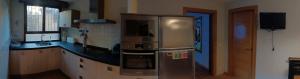 a kitchen with a stainless steel refrigerator and a sink at El rincón de Soto in Anguiano