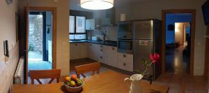 a kitchen with a table with a bowl of fruit at El rincón de Soto in Anguiano