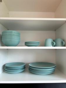 a group of plates and bowls on a shelf at Charming Apartement Luxembourg City Center, Parking, Balcony in Luxembourg