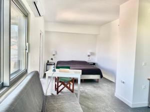 a bedroom with a bed and a white table at P C Side NEST in Xylokastro