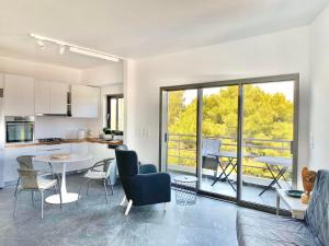 a kitchen and living room with a table and chairs at P C Side NEST in Xylokastro