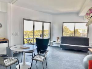 a living room with a table and chairs and a couch at P C Side NEST in Xylokastro