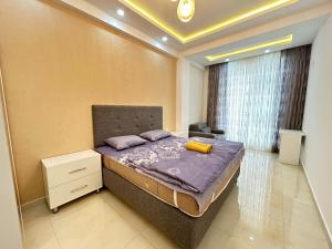 A bed or beds in a room at Whitestone Residence 74