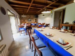 Casa do Fieiro في Miñortos: غرفة طعام مع طاولة وكراسي زرقاء