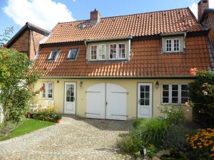 a house with white doors and a red roof at Torhaus in Lüneburg
