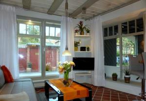 a living room with a couch and a table with flowers on it at Torhaus in Lüneburg
