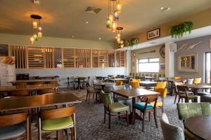 Un restaurante con mesas y sillas en una sala. en Static Holiday Caravan, en Clacton-on-Sea