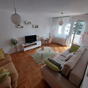 a living room with a couch and a table at Apartment Meli Varazdin in Varaždin