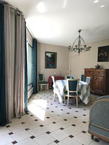 a living room with a table and chairs at Thebertisa in Valréas
