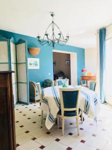 a dining room with a table and chairs at Thebertisa in Valréas +7 photos