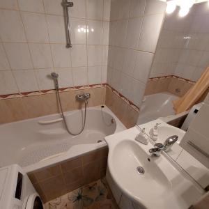 a bathroom with a tub and a sink and a bath tub at Apartment Meli Varazdin in Varaždin