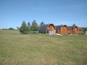 a barn in the middle of a field at Palmse by Kohvikann in Palmse