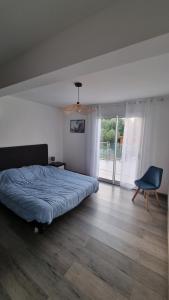 a bedroom with a bed and a chair in it at Villa Vellutini in Calvi +16 photos