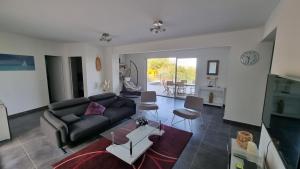 a living room with a couch and a table at Villa Vellutini in Calvi