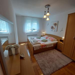 a bedroom with a bed and a teddy bear in it at Apartment Meli Varazdin in Varaždin