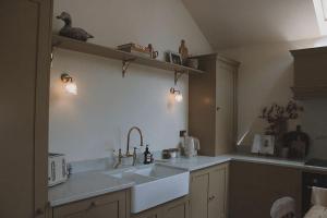 a kitchen with a sink and a counter top at Stock Barn in Youlgreave +49 photos