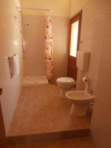a bathroom with a toilet and a sink at B&B Neverland in Marrùbiu +16 photos