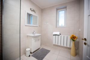 a white bathroom with a sink and a mirror at Zakątek River in Rajgród +28 photos