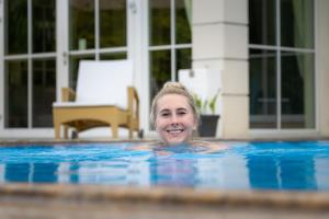 a woman in a swimming pool at Grandhotel Lienz Business-Wellness & Gourmet in Lienz
