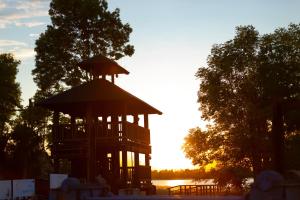 a gazebo with the sunset in the background at Zakątek River in Rajgród