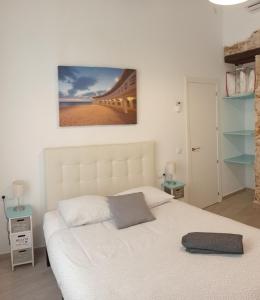 a bedroom with a white bed and a bridge at La Caleta de Cadiz WiFi in Cádiz