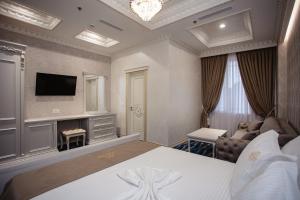 Postel nebo postele na pokoji v ubytování Ervini Boutique Hotel