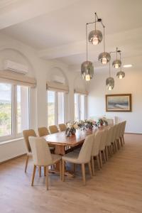 a dining room with a wooden table and chairs at Tatoi Estate Luxury Pool Villa in Athens