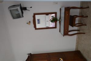 a mirror and a tv on a wall at Villa Georgia in Perissa