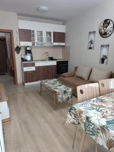 a living room with a couch and a table at Megi Luxury Apartments in Pomorie