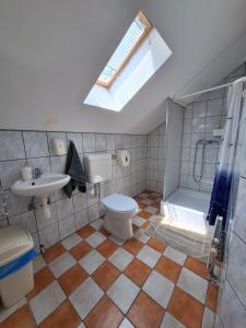a bathroom with a toilet and a shower and a sink at Lila Akác Vendégház Esztergom in Esztergom +20 photos