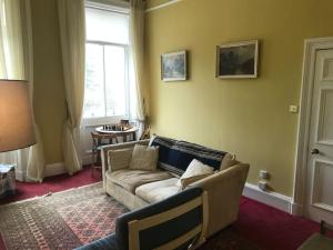a living room with a couch and a window at Tay View in Perth