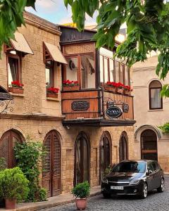 een auto geparkeerd voor een gebouw bij Perla De Mar Hotel in Baku