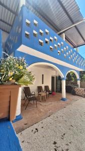 a large blue building with chairs and a table at Casa Constanza in Valladolid