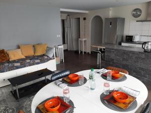 a living room with two tables and a couch at Appart cosy aux écluses du port in Morlaix