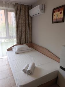 a bed in a room with two towels on it at Megi Apartments, Nesebar sity in Nesebar