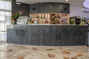 a bar in a room with a counter at Hotel Continental in Caorle