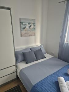 a bedroom with a bed with two birds on the wall at Apartment Perla in Dinjiška