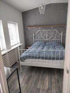 een slaapkamer met een wit bed en een zwarte muur bij Solstice, quiet cottage in Bruinisse, Zeeland in Bruinisse
