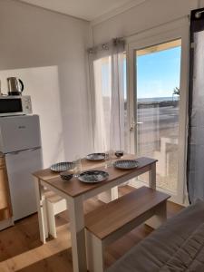 a kitchen with a table with glasses on it at Studio Mimizan plage bord du courant in Mimizan