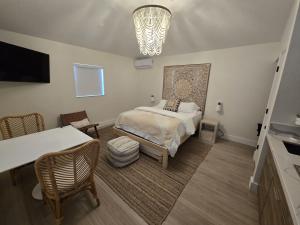 a bedroom with a bed and a chandelier at Seahorse Beach Bungalows in Fort Pierce
