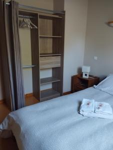 a bedroom with a bed with two towels on it at Les Baillis in Villegenon +22 photos