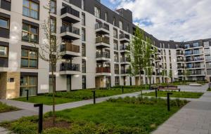 an apartment building with a park in front of it at Imperial Citi Yes Apartament in Krakow