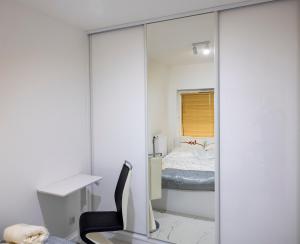 a bedroom with a mirror and a desk and a bed at Imperial Citi Yes Apartament in Krakow