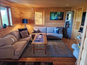 a living room with a couch and a coffee table at Camp Oinas in Hammerfest