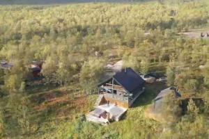 an aerial view of a house in the woods at Camp Oinas in Hammerfest