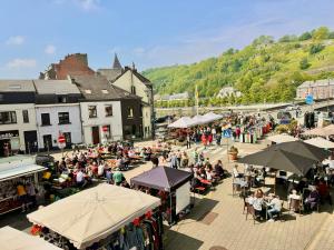 a crowd of people sitting at tables in a market at Royal Casino Namur Balcony in Namur